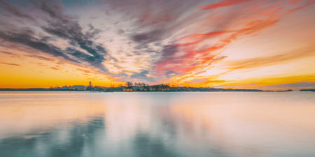 Helsinki, Finland. Panorama Panoramic View Of Suomenlinna Church In Fortress Of Suomenlinna Or Sveaborg And Partially Fortified Island Harakka On Sunrise Sunset Timeの写真素材