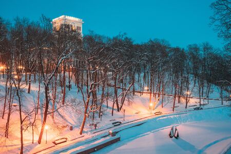 Gomel, Belarus. City Park In Winter Night. Clock Tower Of Rumyantsevs And Paskeviches Palace And Frozen Pond In Homiel Park, Belarus. Famous Local Landmark In Snowの写真素材