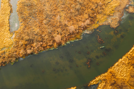 Aerial View Of Dry Grass On Coast And Partly Frozen River Landscape In Late Autumn Day. High...
