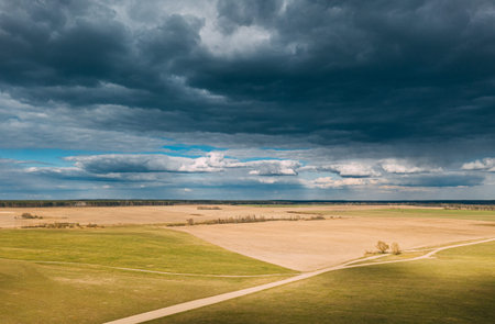 Aerial View. Amazing Natural Dramatic Sky With Rain Clouds Above Countryside Rural Field Landscape...