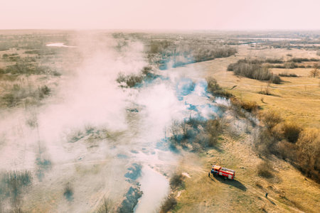 Aerial View. Spring Dry Grass Burns During Drought Hot Weather. Bush Fire And Smoke. Fire Engine,...
