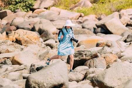 Kanica, Goa, India. People Standing On Pile Of Stones And Taking Photo At Sunny Summer Dayの写真素材