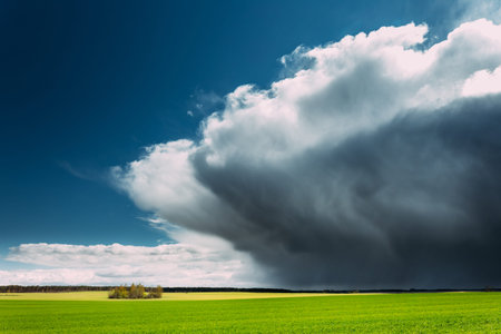 Storm And Rain Above Countryside Rural Field Or Meadow Landscape With Green Grass Under Scenic...