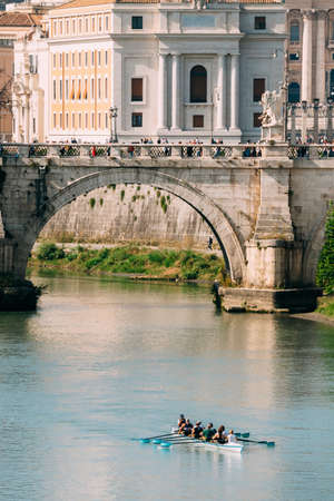 Rome, Italy. Group Of People Training On Kayak. Sightseeing Boat Floating Near Aelian Bridge. Tour Touristic Boatの写真素材