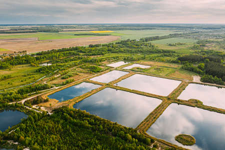 Aerial View Retention Basins, Wet Pond, Wet Detention Basin Or Stormwater Management Pond, Is An Artificial Pond With Vegetation Around The Perimeter, And Includes A Permanent Pool Of Water In Its Design.の写真素材