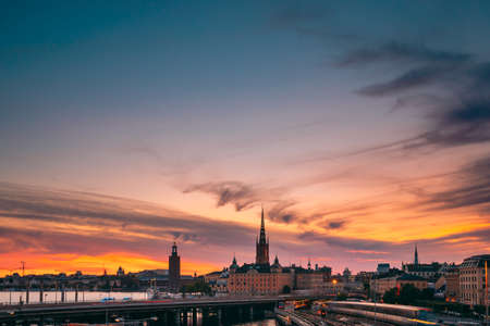 Stockholm, Sweden. Scenic View Of Stockholm Skyline At Summer Evening. Famous Popular Destination Scenic Place Under Dramatic Sky In Sunset Lights. Riddarholm Church, Subway Railwayの写真素材