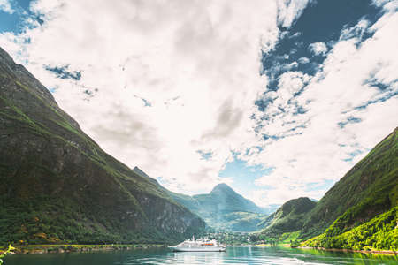 Geirangerfjord, Norway. Touristic Ship Ferry Boat Cruise Ship Liner Floating Near Geiranger In Geirangerfjorden In Sunny Summer Day. Famous Norwegian Landmark And Popular Destination.の写真素材