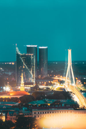 Riga, Latvia. Aerial View Of Night Cityscape In Evening Night Lights Illumination. Vansu Cable-stayed Bridgeの写真素材
