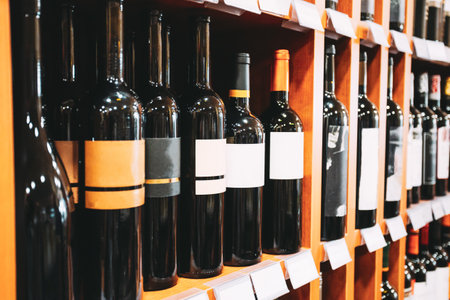 Showcase With Wine Bottles At The Wine Store. Wall With Alcoholic Drinks Wine Bottles On Shelvesの写真素材