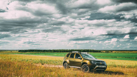 Renault Duster SUV in summer meadow landscape. Duster produced jointly by French manufacturer Renault and its Romanian subsidiary Daciaのeditorial素材