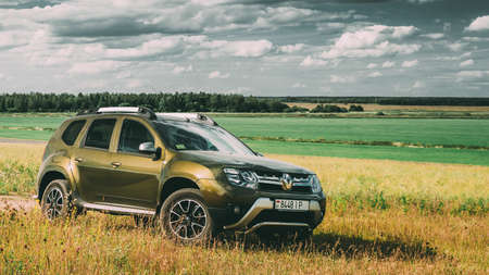 Renault Duster SUV in summer meadow landscape. Duster produced jointly by French manufacturer Renault and its Romanian subsidiary Daciaのeditorial素材