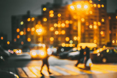 Defocused Abstract Boke Bokeh Urban City Background Effect. Blurred Design Backdrop In Trend 2021 Colors Yellow And Gray Grey. City Circle Street Defocused Lights Glowing In Night. Pedestrian Crossing In Shiny Spots. Urban Vibrant Background Ideal For Design And Artwork With Copy Space.の写真素材