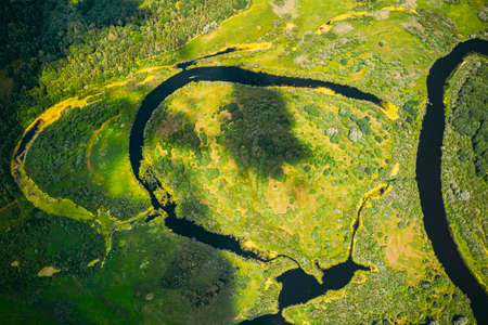 Aerial View Green Forest Woods And River Landscape In Sunny Spring Summer Day. Top View Of Beautiful European Nature From High Attitude In Autumn Season. Drone View. Birds Eye Viewの写真素材