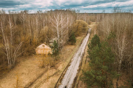 Belarus. Old Abandoned Barn Near Country Road, Farm House In Chernobyl Resettlement Zone. Chornobyl Catastrophe Disasters. Dilapidated House In Belarusian Village. Whole Villages Must Be Disposedの写真素材