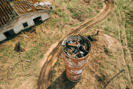 Belarus. Aerial View Of Abandoned Ruined Water Tower Near Farm In Chernobyl Zone. Chornobyl Catastrophe Disasters. Dilapidated House In Belarusian Village. Whole Villages Must Be Disposed. Chernobyl Resettlement Zone.の写真素材