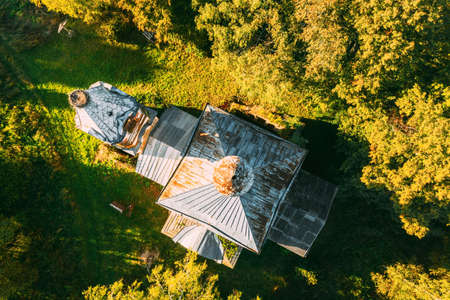 Martinovo, Beshenkovichsky District, Vitebsk Region, Belarus. Bird's-eye View Of Church Of The Intercession Of The Most Holy Theotokos. Aerial View Of Historic Landmark In Autumn Sunny Evening. Flat View.の写真素材