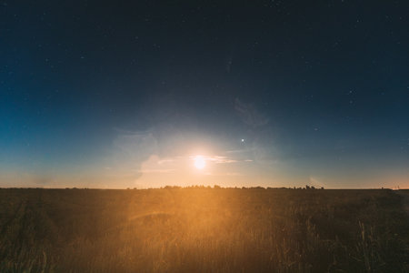 Moonrise Above Summer Filed. Night Countryside Summer Starry Night Sky landscapeの写真素材