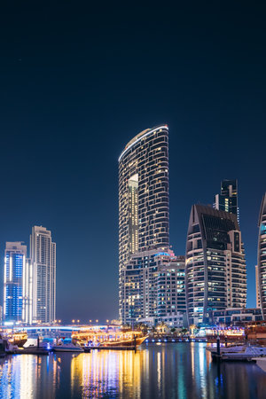 Night view Of Dubai Marina Towers. Yachts Moored Near City Pier, Jetty In Evening Night Illuminationsの写真素材