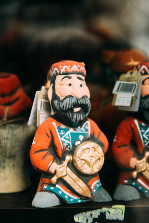 Popular Souvenirs is Dolls In The Similitude Of Caucasus Georgian warrior Man In Traditional Clothes. Man holding shield and swordのeditorial素材