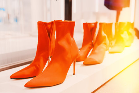 red chamois female suede ankle boots on shelf display in shop mall store. velour boots. Store Of Shopping Center. retail saleの写真素材
