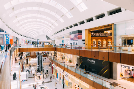 Dubai, UAE, United Arab Emirates - May 28, 2021: People visiting Dubai shopping mall. People going shopping in shopping center indoor. People resting at modern Dubai shopping mall centreのeditorial素材