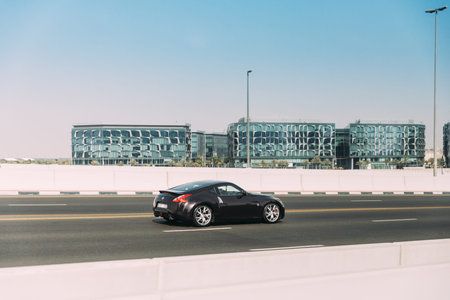 Dubai, UAE, United Arab Emirates - May 28, 2021: Black Nissan 350Z car fast mooving on street in...