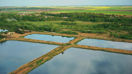 Aerial View Retention Basins, Wet Pond, Wet Detention Basin Or Stormwater Management Pond, Is An Artificial Pond With Vegetation Around The Perimeter, And Includes A Permanent Pool Of Water In Its Design.の写真素材
