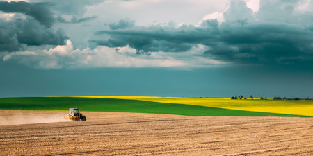 Tractor Plowing Field In Spring Season. Beginning Of Agricultural Spring Seasonの写真素材