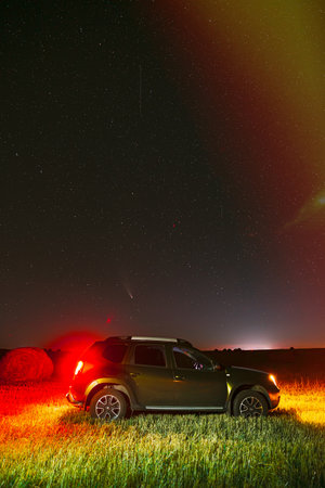 Renault Duster Or Dacia Duster Suv In Night Summer Meadow Landscape With Hay Bale After Harvest. Duster Produced Jointly By French Manufacturer Renault And Its Romanian Subsidiary Dacia Since 2010のeditorial素材