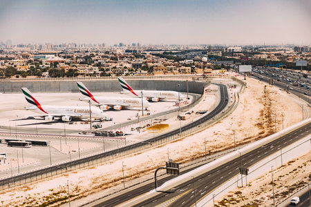 Airline Emirates Plane Stand At Dubai Airport. Dubai, United Arab Emirates. View Of Cityscapeのeditorial素材