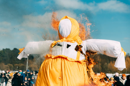 Burning Effigies Straw Maslenitsa In Fire On Traditional National Holiday Dedicated To Approach Of Spring - Slavic Celebration Shrovetide. Belarusの写真素材