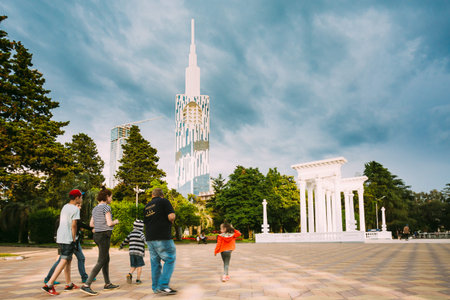 Batumi, Adjara, Georgia. Family people walking with children on Batumi Boulevard street near waterfront.のeditorial素材
