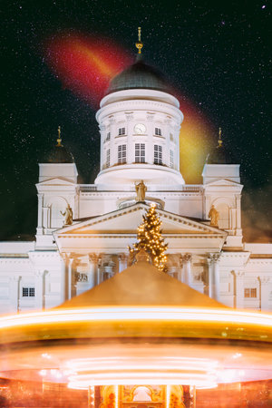 Night Dark Blue Sky Glowing Stars Background. Helsinki, Finland. Xmas Christmas Market On Senate Square With Holiday Carousel And Famous Landmark Is Lutheran Cathedral In Winter Nightの写真素材