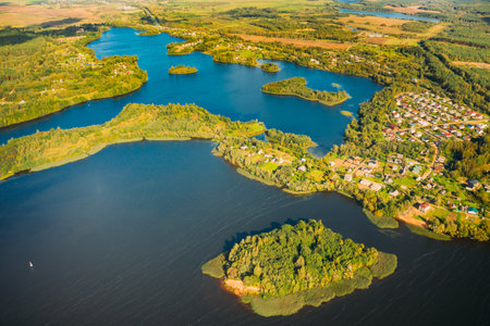Lyepyel District, Lepel Lake, Beloozerny District, Vitebsk Region. Aerial View Of Residential Area With Houses In Countryside. Top View Of Island From High Attitude In Autumn Sunny Day. Bird's Eye View. Flat View.の写真素材