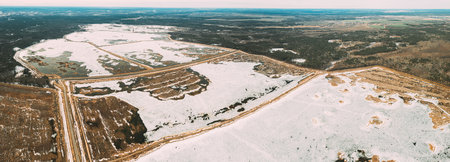 Aerial View Of Road Through Ponds In Winter Snowy Landscape. Frozen Ponds Of Fisheries In South Of Belarus. Top View Of Fish Farms From High Attitude. Drone View. Birds Eye Viewの写真素材