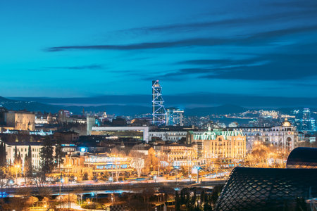 Tbilisi, Georgia. modern highrise building in Urban Cityscape during evening lights. Elevated view Tbilisi skyline during sunsetの写真素材