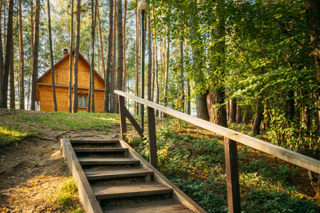 Tourist Guest House For Rest. Wooden House In Forest In Autumn Sunny Dayの写真素材