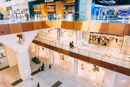 Dubai, UAE, United Arab Emirates - May 22, 2021: View of the Dubai mall indoor. People visiting Dubai shopping mall. People going shopping in shopping center indoor. People resting at modern shopping mall centreのeditorial素材