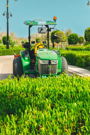 Dubai, UAE, United Arab Emirates - May 25, 2021: John Deere Compact Utility Tractor 4066M parked on...