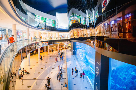 Dubai, UAE, United Arab Emirates - May 28, 2021: Aquarium of the Dubai mall. People visiting Dubai shopping mall. People going shopping in shopping center indoor. People resting at modern shopping mall centreのeditorial素材