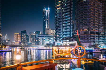 Dubai Marina Port, UAE, United Arab Emirates - May 19, 2021: Night Walk On Tourist Boat, Sightseeing Boat Sailing On Dubai Marina. Night View Of Dubai Marina Is District in Dubai, United Arab Emiratesのeditorial素材