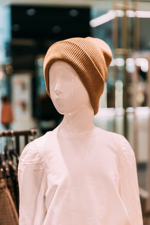 Casual warm Hat On Mannequin In Store Of Shopping Center. shelf display in shop mall store. Store Of Shopping Center. retail saleの写真素材
