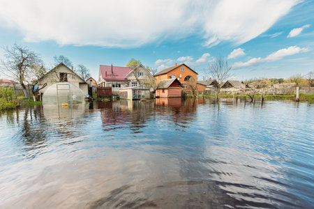 Vegetable Garden Beds In Water During Spring Flood floodwaters during natural disaster. Greenhouse Hothouse in Water deluge During A Spring Flood. inundation Riverの写真素材
