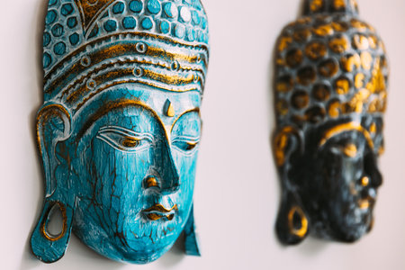 Handmade souvenirs buddha mask on white background. Isolated on white. Close up detailsの写真素材