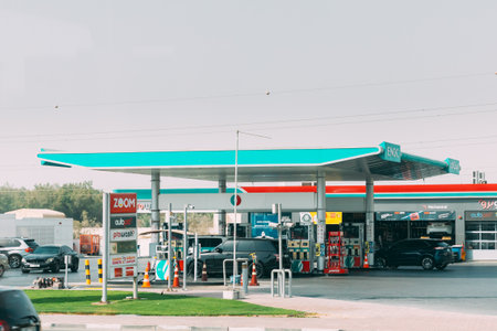 Dubai, UAE, United Arab Emirates - May 28, 2021: Car refuel at ENOC oil station in sunny summer day. ENOC, Emirates National Oil Company is global diversified state owned energy group and operates in oil, gas and coal industryのeditorial素材