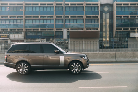 Dubai, UAE, United Arab Emirates - May 28, 2021: Black 2013 Range Rover Vogue car fast mooving on street in Dubai. Land Rover Range Rover Voque is series of subcompact luxury crossover SUVs produced by Jaguar Land Rover, a British car manufacturer. Urban のeditorial素材
