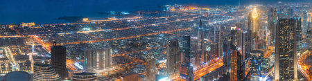Dubai, UAE, United Arab Emirates - May 25, 2021: Aerial View Of Beautiful Evening Night Scenic View Of Cityscape Background. Waterfront And Dubai Skyscraper In Evening Night Illumination. High quality photo. Panorama, Panoramic Viewのeditorial素材
