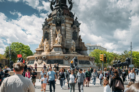 Barcelona, Catalonia, Spain - May 13, 2018: Tourists Walk Near The Columbus Monument Is A 60 M Or 197 Ft Tall Monument To Christopher Columbus. Travel to Barcelonaのeditorial素材