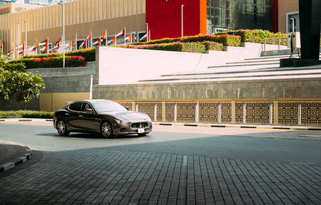 Dubai, UAE, United Arab Emirates - May 28, 2021: Black Maserati Quattroporte car fast mooving on street in Dubai. Maserati Quattroporte is a four-door full-size luxury sports saloon produced by Italian automobile manufacturer Maseratiのeditorial素材