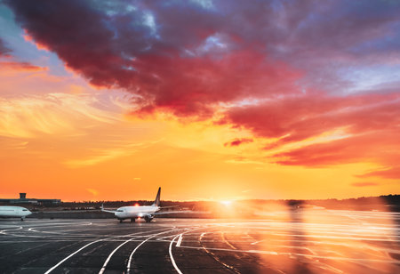 Aircraft Plane Parking In Airport During Sunny Sunset Sunriseの写真素材